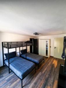 two bunk beds in a room with wooden floors at Borgo Emilius - CIR 0053 in Villefranche