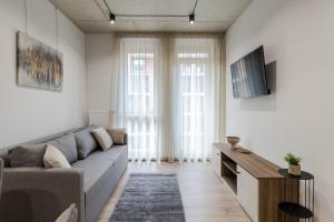 a living room with a couch and a tv at Prime Rest Apartments in Lviv