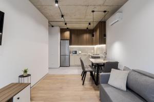 a living room with a couch and a table at Prime Rest Apartments in Lviv