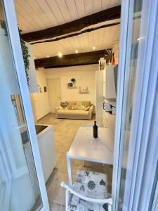 a kitchen and living room with a white table and chairs at Charming apartment in Monterosso al Mare with balcony in Monterosso al Mare