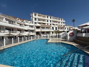 a large swimming pool in front of a building at Loft 19 Luxury Suite Boutique - Heated pool in Los Cristianos