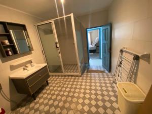 a bathroom with a sink and a mirror at La-Villa-m Douala in Douala +16 photos
