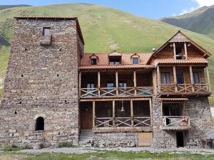 an old stone building with a green hill in the background at Truso Guesthouse in Abano +23 photos