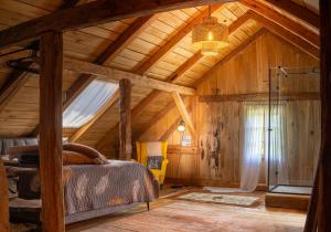 a bedroom with a bed and a wooden ceiling at Estate Ana in Ptuj