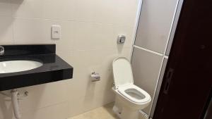 a bathroom with a toilet and a sink at Hotel Jatobás Sinop in Sinop +12 photos