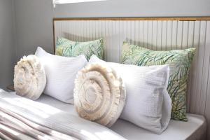 a bunch of pillows sitting on a bed at Desert Nest II in Swakopmund