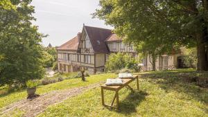 an old house with a bench in front of it at La Suite du Manoir - Champagne et Sérénité in Chappes