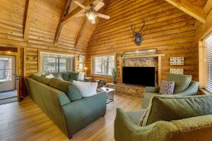 a living room with couches and a flat screen tv at Covered Deck, Private Acreage: Log Cabin in Pine in Pine