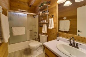 a bathroom with a toilet and a sink and a mirror at Covered Deck, Private Acreage: Log Cabin in Pine in Pine +23 photos