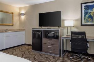 a hotel room with a television and a desk and chair at Best Western Heritage Inn in Concord
