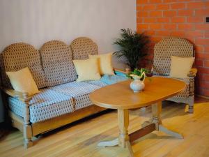 a living room with a couch and a table at Apartment at Leszego in Bolków