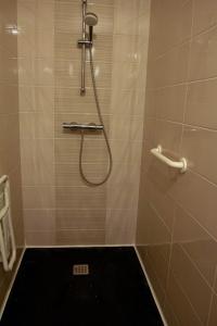 a bathroom with a shower with a black rug at Cozy house with garden, comfort for 6 people in Maulévrier +16 photos