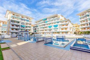 a large apartment complex with a swimming pool and buildings at Paradiso de Playa LaMata in La Mata