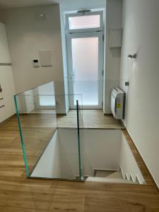 a glass staircase in a room with a window at Mariaaltomare in Andria