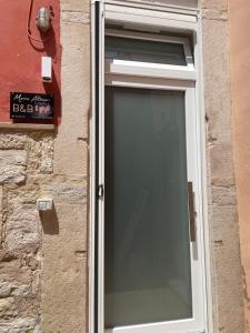a window on the side of a brick building at Mariaaltomare in Andria +1 photo