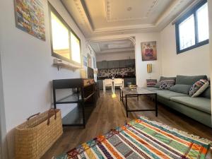 a living room with a couch and a table at Nour roof top apartment in Essaouira