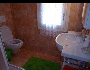 a bathroom with a toilet and a sink at Affittasi casa Fetovaia Isola D'Elba in Fetovaia