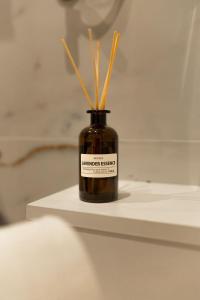 a jar with sticks in it sitting on a table at Benny & Bella Central Apartments in Oradea