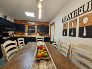 a wooden table with a tray of fruit on it at Saluda Summit Cabin at Cabin Fever in Saluda
