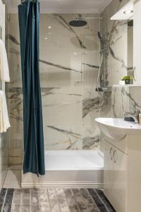 a bathroom with a shower and a sink at Benny & Bella Central Apartments in Oradea +63 photos