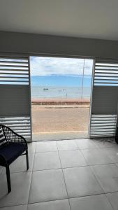a empty room with a view of the beach at Casa do Airton in Icapuí