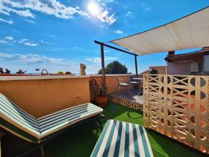 a balcony with chairs and a table on a roof at Carabassi playa in Gran Alacant