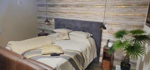 a bedroom with a bed with a blue headboard and a couch at Cabaña Shekinah con vista panoramica Tibasosa in Tibasosa
