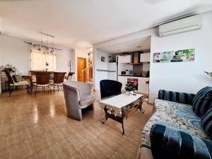 a living room with a couch and a table at Carabassi playa in Gran Alacant
