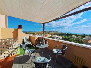 a patio with chairs and a table on a balcony at Carabassi playa in Gran Alacant +61 photos