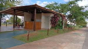 a building with a pavilion with a fence around it at Diamante em Brasília in Brasilia