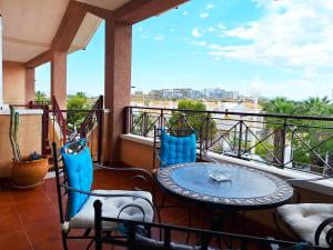 a patio with a table and chairs on a balcony at Carabassi playa in Gran Alacant