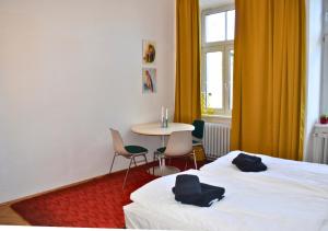 a bedroom with a bed and a table and chairs at vintage house - LGBTQ & female friendly in Vienna