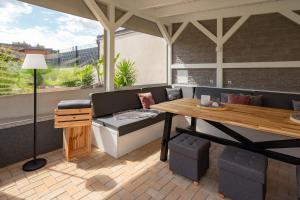 a patio with a table and a bench and a table at Ferienhaus Nißmitz No.32 in Freyburg