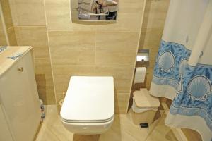 a bathroom with a toilet and a shower curtain at Katia's House in Ampavris +54 photos