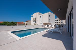 a swimming pool on the side of a building at Villa Vibiana Lux Bibinje in Bibinje