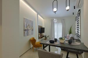 a living room with a table and a couch at OMEGA - Deluxe Central Apartment by Optimum Link in Katerini