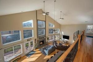a living room with a couch and a fireplace at Lakeshore Retreat with Lake Lanier views & hot tub in Landrum