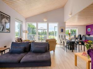 a living room with a couch and a dining room at 3 Bed in Hopton 88649 in Fritton Norfolk