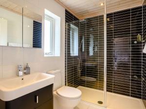 a bathroom with a toilet and a sink and a shower at 3 Bed in Hopton 88649 in Fritton Norfolk +15 photos