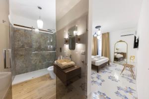 a bathroom with a shower and a toilet and a sink at Casa Zio Lele in Cefalù