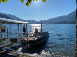 a boat parked next to a dock on a lake at Il Cortiletto - Cozy Apt Brand New Equipped Private Garden - BBQ in Como