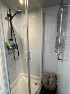 a shower with a glass door in a bathroom at Clovelly Suite Four Poster Bed & Breakfast in Westward Ho