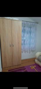 a wooden cabinet in a room with a window at Dolina Mira-Plav in Plav