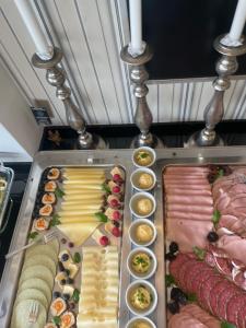 a display case filled with different types of food at HOTEL Amber Suite & SPA - Enklawa dla Dorosłych in Międzywodzie