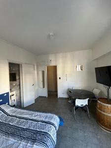 a bedroom with a bed and a table and a tv at Un lugar unico, cerca del Colon in Buenos Aires