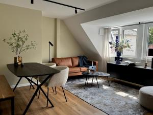 a living room with a table and a couch at Emils City Suite in Vreden