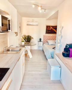 a small kitchen with a bed in a small room at Maison du bonheur in Cagnes-sur-Mer