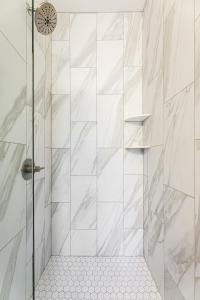 a bathroom with a shower with white tiles at Hamilton Place Bayside Building 301 B in Traverse City +29 photos