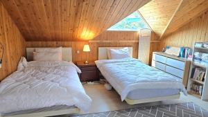 Ένα ή περισσότερα κρεβάτια σε δωμάτιο στο Badagaboineun Pension