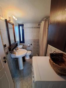 a bathroom with a sink and a toilet at DaGiorgio in Pitsiniánika +64 photos